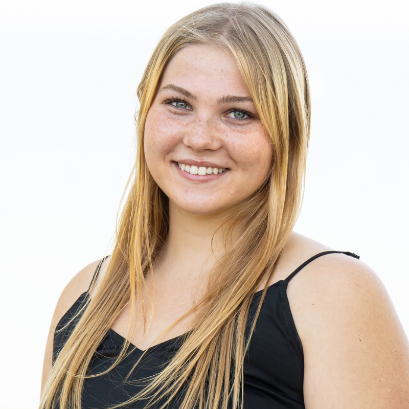 Headshot of a blonde individual smiling.